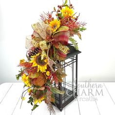 a lantern filled with sunflowers and fall leaves