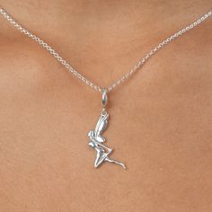 This sterling silver fairy charm necklace boasts art deco design influences. She stands ready to sprinkle magic wherever she flies. Enjoy the charm of our fairy pendant, perfect for anyone who wants a touch of magic in their life.  All our charms attach with a clip-on clasp and are compatible with all other leading charm jewellery brands. Simply clip-on or slide-on to a chain, charm bracelet or charm carrier necklace.  All Lily Charmed jewellery comes presented in a beautiful gift box. Material: 100% Recycled 925 Sterling Silver.  At Lily Charmed, we strive to provide our customers with the highest quality jewellery. All our pieces are made from high quality 925 Sterling Silver and Gold-plated sterling silver and with proper care and maintenance it will last a lifetime.  To keep in perfect Fairy Charm Necklace, Fairy Jewellery, Childrens Necklace, Silver Fairy, Chain Charm Bracelet, Fantasy Necklace, Matching Jewellery, Fairy Pendant, Fairy Charms