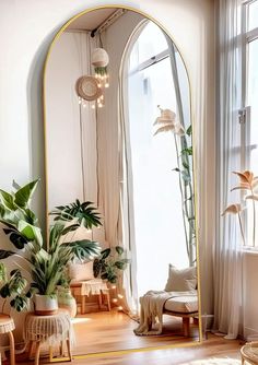 an arched mirror in a living room next to a chair and table with potted plants