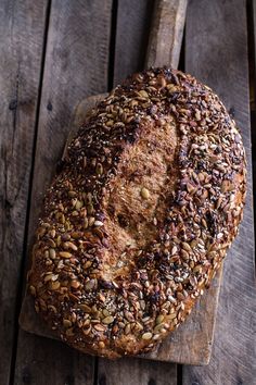 a loaf of bread sitting on top of a wooden cutting board