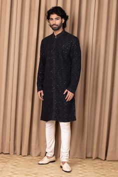 Black straight kurta with floral jaal embroidery on the front and sleeves. Comes with an ivory churidar.
Component: 2
Pattern: Embroidered
Type Of Work: Floral Jaal Patterns
Neckline: Mandarin Collar
Sleeve Type: Straight Long
Fabric: Cotton and Silk
Color: Green
Other Details: 
Front button down
Note: Pant worn by the model is not for sale
Occasion: Mehendi and Puja - Aza Fashions Resham Embroidery Bandhgala Straight Kurta, Jamawar Kurta With Resham Embroidery For Reception, Formal Traditional Wear With Mirror Work Straight Kurta, Semi-stitched Chikankari Kurta For Reception, Formal Straight Kurta With Mirror Work, Designer Cotton Silk Sherwani With Zari Work, Long Sleeve Cotton Silk Sherwani With Dabka Work, Straight Kurta With Dabka For Reception, Straight Kurta For Reception With Dabka