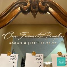 an ornate mirror with place cards on it in front of a sign that says our favorite people