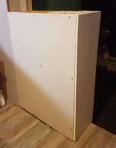 an unfinished kitchen cabinet in the process of being built with plywood and wood flooring