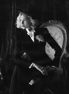 black and white photograph of a woman sitting on a chair