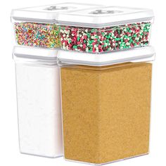 three plastic containers with sprinkles on the lids are stacked up against each other