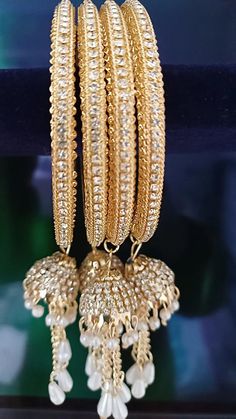 Gold Plated Finish Premium Quality American Diamond/CZ Bangles/ CZ Bbraceletss/ Party Wear Bangles/ CZ Stone bangles/Wedding/bridal jewelry Sold as Set of 4 pieces. Premium Quality Gold Plated Finish American Diamond Jhumki with Pearl Drops is a perfect gift, for party wear, weddings, and special occasions. Sizes - 2.4, 2.6 and 2.8 inches. Jeweled Round Bangle For Wedding, Gold Bangle With Jewels For Weddings, Gold Jeweled Bangle For Wedding, Gold Wedding Bangle With Jewels, Heavy Bangle Jewelry For Celebration, Heavy Bangle For Celebrations, Traditional Jeweled Bangle For Festive Occasions, Diamond Bangle With Stone Work, White Bollywood Bracelet With Stone Work