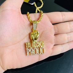 14k Gold Finish Black And Proud Simulated Diamond Hip Hop Pendant W/ Rope Chain. Condition Is New With Tags. Shipped With Usps First Class Package. Metal - Brass Width - 31.6 Mm Height - 43.2 Mm Gold Rope Chain Jewelry For Streetwear, Gold Rope Chain Jewelry, Personalized Black Jewelry For Streetwear, Black And Proud, Layered Cross Necklace, Hammered Necklace, Black Wedding Band, Tungsten Wedding Rings, Tigers Eye Necklace