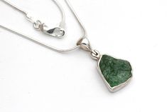 Beautiful, AAA quality raw emerald necklace. The stone measures 1/2 inch tall X 3/8 inch wide and is set in a solid sterling silver bezel setting. Hung from a solid sterling silver, snake chain, you can choose from either 16, 18 or 20 inch lengths. Thank you for shopping and supporting artists! Sterling Silver Emerald Pendant Necklace Gift, Sterling Silver Pendant With Raw Stone, Gift Sterling Silver Emerald Necklace With Natural Stones, Green Emerald Pendant Necklace In Sterling Silver, Sterling Silver Pendant Emerald Necklace With Natural Stones, Elegant Untreated Green Jewelry, Green Sterling Silver Jewelry With Raw Stone, Untreated Emerald Jewelry For Anniversary, Iron Anniversary Gifts