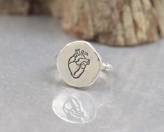 Sterling silver anatomical heart ring Artisan handmade  Rustic style 14 gauge sterling silver half round band -Size fo heart:12 mm -Please choose your size at check-out All metals used: 925 sterling silver, 999 fine silver, 14K gold All gemstones are semiprecious All of my jewelry comes nicely packaged I am open to making custom pieces Please click here to visit shop: https://www.etsy.com/shop/NatureJourney Thank you for visiting! Real Heart, Jewelry Real, Nurse Doctor, Anatomical Heart, Medical Students, Nursing Students, Handmade Artisan, Rustic Style, Fine Silver