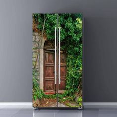 an open door in the middle of a room with vines growing on it and a wooden door