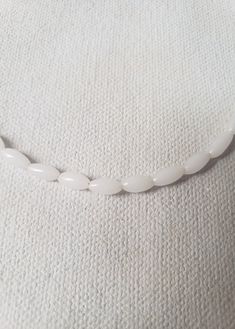 These beautiful pearly white Japanese Seed Beads are a perfect layering option for your summer look! 16 inches in length *Colors may vary. Minimalist Beaded Necklace With Pearl Drop, White Handmade Beads, Everyday Beaded Pearl White Pearl Necklace, Minimalist White Beaded Necklace For Everyday, White Beaded Necklace With Pearl Drop For Gift, Gift White Beaded Necklace With Pearl Drop, Delicate Pearl White Beaded Necklace With Round Beads, Minimalist White Pearl Beaded Necklaces, Everyday White Single Strand Beaded Necklace