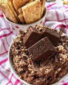 a bowl filled with chocolate and some crackers