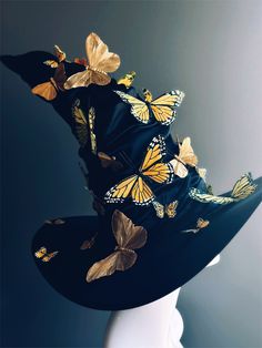 a black hat with gold butterflies on it