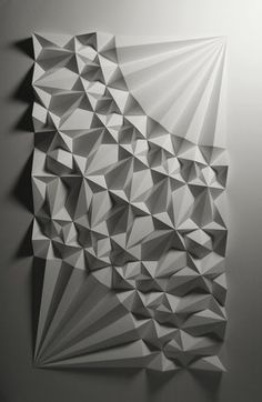 an abstract piece of paper that looks like it is made out of white and black geometric shapes