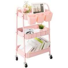 a pink rolling cart with books and magazines on it