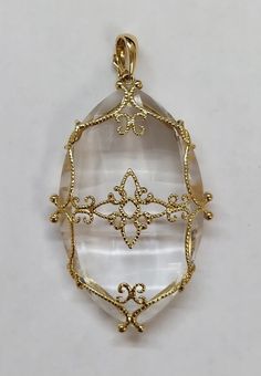 14 Karat Yellow Gold Caged Quartz Crystal Pendant : * 14 KARAT YELLOW GOLD , CAGED QUARTZ CRYSTAL PENDANT . * WEIGHTS 20.9 GRAMS . * IT IS ABOUT 60 MM HEIGHTS WITH BAIL , AND 33 MM WIDE. * THE BAIL CAN BE OPEN TO INSERT THE CHAIN  IN. * PREOWNED, IN GEAT CONDITION. Elegant Necklace With Large Clear Pendant, Elegant Clear Necklace With Large Pendant, Elegant Clear Pendant Jewelry, Sphere Necklace, Quartz Crystal Pendant, Topaz Pendant, Beaded Pendant, Gold Yellow, Crystal Pendant