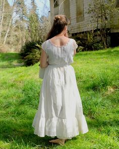 "Antique petticoat with 22\" waist. White cotton with smooth touch and light crispness. Flounce at hem with pin tucks and lace trim. Pale yellow and white ribbon detail at top of flounce. Single button closure at back with \"cheat\" string loop for an additional inch. Flat front waist with tight gathers at back. Very good condition, some small rust spots found on flounce (see last photo for example of majority of it). Measures 34\" long." White Regency Style Petticoat With Ruffles, Regency Style Ruffled Petticoat For Daywear, Daywear Tiered Petticoat With Ruffles, Daywear Ruffled Tiered Skirt Petticoat, Daywear Tiered Skirt Petticoat With Ruffles, Daywear Ruffled Petticoat, Spring Daywear Petticoat With Gathered Skirt, Cotton Lace-trimmed Petticoat For Daywear, Fitted Ruffled Petticoat For Daywear