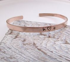 "Cuff Bracelet - skinny stacking bracelet - Valentine's Day gift for her - Couples Bracelet - Girlfriend Gift One 1/8\" x 6\" rose gold filled cuff bracelet made from 18 gauge rose gold filled sheet. It is stamped with the initials of your choice with a cute little <3 in between. Please just leave the initials to stamp in the notes to seller box. As with all hand stamped jewelry, each piece is made just for you, so there may be slight differences. This is not to be seen as a defect, but as pa Minimalist Stackable Cuff Bracelet For Gift, Minimalist Stackable Cuff Bracelet As Gift, Minimalist Stackable Cuff Bracelet Gift, Simple Adjustable Bangle As A Gift, Everyday Stackable Rose Gold Cuff Bracelet, Rose Gold Stackable Cuff Bracelet For Everyday, Adjustable Simple Cuff Bracelet As Gift, Simple Bangle Cuff Bracelet Gift, Simple Cuff Bangle Bracelet As Gift