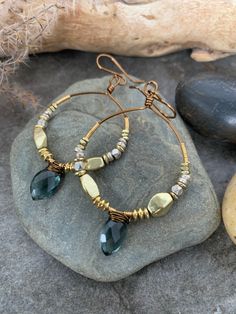 Gorgeous and super stylish gemstone beaded hoop earrings .., crafted with bronze hand forged hoops beaded with African brass and Silver beads accented with faceted hand wire wrapped Moss Aquamarine gemstones. These show stoppers measure 2.5 inches in length . Hobo Jewelry Bohemian, Custom Made Earrings, Gemstone Beaded Earrings, Bohemian Hoop Wrap Earrings, Bohemian Dangle Hoop Earrings With Faceted Beads, Brass Beaded Dangle Hoop Earrings, Bohemian Hoop Earrings With Faceted Beads, Bohemian Wire Wrapped Dangle Hoop Earrings, Bohemian Style Wire Wrapped Dangle Hoop Earrings