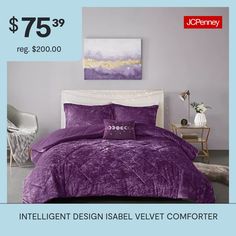 a bed with purple comforter and pillows on it in front of a blue wall