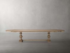 an oval wooden table with two legs on the top and one leg raised to the side