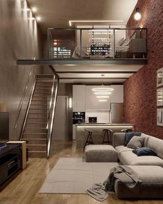 a living room filled with furniture next to a stair case in a home that's built into the side of a brick wall