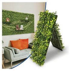 a living room with a couch, chair and green wall hanging on it's side