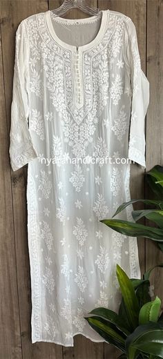 "Trendy \"ghaas patti \" Chikankari white kurta on fine flowy georgette. Beautifully hand embroidered! Liner included. Kurti length-49 inches \"Embroidery designs may slightly vary\"" Luxury Feminine Chikankari Embroidery Sets, Luxury Chikankari Embroidery Tunic Dress, Luxury Chikankari Embroidered Top For Summer, Luxury Chikankari Embroidery Top For Party, Luxury Chikankari Embroidered Top For Wedding, Luxury Chikankari Embroidery Georgette Dupatta, Luxury Chikankari Embroidery Blouse For Festive Occasions, White Bohemian Traditional Wear For Spring, White Traditional Wear For Summer Wedding