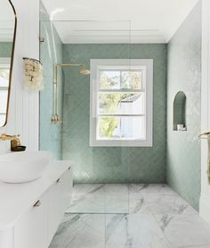 a bathroom with marble floors and green walls