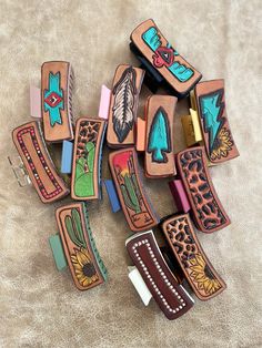 several different types of wooden magnets with designs on them, sitting on a surface