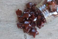 a jar filled with star shaped candies on top of a wooden table