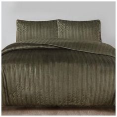 an image of a bed with green comforter and pillows on the bottom half of it