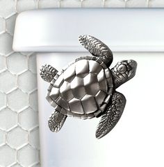 a close up of a toilet with a turtle on it