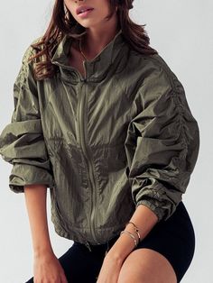 "NO REFUNDS-please check sizing  Small (2/4), Medium (6/8), Large (10/12) Activewear that is stylish and practical with ruched sleeves - lightweight windbreaker jacket. Crafted from 100% nylon, this jacket offers durability and water-resistant properties, making it perfect for unpredictable weather conditions.  This jacket packs down small into for easy carrying and travel. The high neck design provides added protection, while the zip-up front allows for easy on and off. The ruched sleeves add a trendy touch, giving the jacket a unique and fashionable look. With its functional front pockets, you can conveniently store your essentials while on the go. Whether you're heading out for a hike or running errands, this windbreaker jacket is a versatile and must-have addition to your wardrobe. Mod Spring Khaki Outdoor Track Jacket, Green Long-sleeve Outerwear With Drawstring, Stretch Windbreaker For Fall Outdoor Activities, Green Long Sleeve Outerwear With Drawstring, Stretch Windbreaker For Outdoor Activities In Fall, Spring Long Sleeve Track Jacket With Drawstring, Spring Track Jacket With Stretch For Outdoor Use, Winter Long Sleeve Track Jacket With Drawstring, Spring Utility Windbreaker With Drawstring