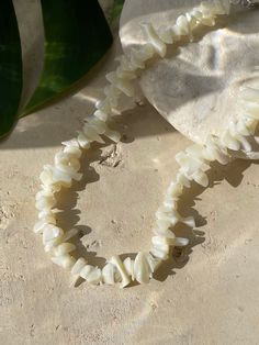 Mermaid - Nature Mother of Pearl Choker is the perfect choice for beach vacation. This seashell choker necklace is made using natural mother of pearl for understated elegance. Available with bracelet, our signature beach accessories are made to match your favorite Coco De Chom designs. Our accessories are handmade in Thailand using eco-friendly materials. A unique nacre choker for your vacation or the bohemian bridesmaids.* Measures approx. 14-16 inches in length* Choker Necklace are ready to sh Beach Shell Necklace Made Of Mother Of Pearl, Beach Shell Necklace In Mother Of Pearl, Beach Shell Necklaces In Mother Of Pearl, White Shell-shaped Choker For Vacation, Vacation Shell Necklace With Mother Of Pearl, Adjustable Ocean-inspired Shell Necklace, Mother Of Pearl Shell Necklace For Vacation, Vacation Mother Of Pearl Shell Necklace, Adjustable Mother Of Pearl Jewelry For Vacation