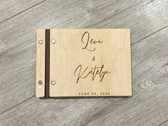 a wooden notebook with the words love and marriage written on it, sitting on a wood floor