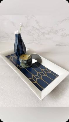 a blue vase sitting on top of a white tray