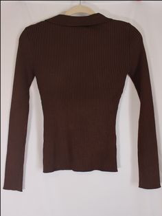 Effortless and classic brown ribbed knit top with stretchy material, long sleeves, v-neckline, and collar detail. details & fit: fits slightly small. 70% viscose, 30% polyester measurements: small: bust 26"/ waist 18"/ length 21" medium: bust 28"/ waist 20"/ length 21.5" large: bust 30"/ waist 22"/ length 22" model details: model is 5'7" and wearing size medium Trendy Brown Long Sleeve Top For Fall, Brown Ribbed Long Sleeve Knit Top, Brown Stretch Turtleneck Tops, Stretch Fine Knit Brown Sweater, Stretch Brown Fine Knit Sweater, Brown Long Sleeve Turtleneck For Fall, Fitted Brown Long Sleeve Turtleneck, Fitted Brown Turtleneck With Long Sleeves, Brown Stretch Tops For Fall