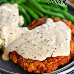 the ultimate chicken fried steak is served with gravy and green beans