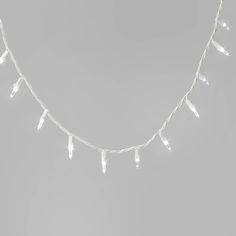 white christmas lights are hanging on a string