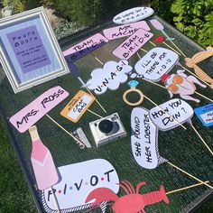 a table topped with lots of different types of paper cut outs and pictures on sticks