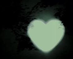 a white heart shaped object in the dark