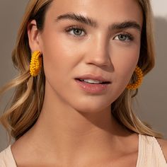 Make a statement this summer with our Beaded Hoops. These dark yellow beaded earrings pair perfectly with all of your favorite gold earrings and all of our other beaded jewelry. Add these statement hoop earrings to your collection and you’ll have an unforgettable look all season long. Yellow Hoop Earrings For Summer, Yellow Hoop Earrings For Summer Beach, Yellow Hoop Earrings For Spring, Trendy Yellow Earrings With Colorful Beads, Summer Gold Beaded Earrings, Trendy Summer Beaded Earrings, Yellow Beaded Hoop Earrings For Summer, Colorful Bead Earrings For Spring, Gold Beaded Hoop Earrings For Summer