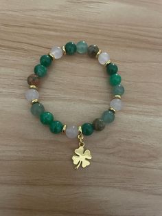 This stretchy bracelet features beautiful beads and stones and features a lucky shamrock charm. Quick shipping. Good Luck Adjustable Beaded Bracelets With Natural Stones, Good Luck Gemstone Beaded Bracelets, Green Beaded Bracelets For Good Luck, Shamrock Bracelet, Lucky Shamrock, Irish Shamrock, Stretchy Bracelets, Charm Bracelets, Wedding Gifts