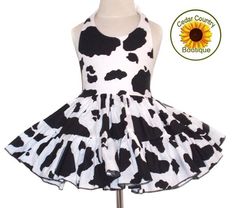 This fun little sundress is so adorable for your little cowgirl. Made with a cow print halter top attached to a very full hand ruffled two tier cow print twirly square dance skirt. 100% cotton dress has ribbon ties at neck and elastic at back waist to make it adjustable and child can wear longer. Skirt is made extra full for little cowgirl’s twirling fun. Made in the USA.Dress is shown with one of my double layer petticoats under for added fullness, not necessary, but lots of fun! Sizes: 3-6M, 6 White Twirl Dress For Summer Fun, Fitted Twirl Dress For Beach In Spring, Cute Fitted Twirl Dress For Beach, Playful Fitted Sleeveless Twirl Dress, Fitted Twirl Dress For Beach, Playful Fitted White Sundress, Sleeveless Fitted Twirl Dress For Beach, I Love Lucy Costume, Cow Print Fabric