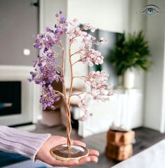 a person holding a vase with flowers in it