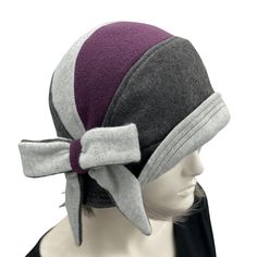 HANDMADE IN THE USAThe thoroughly modern Millie. A 1920's fleece cloche hat for Women with a large bow accessory. Winter season fashion shown here in a dark gray and pale gray with a contrast of eggplant fleece. This hat has a sculpted crown and a narrow brim that frames the face. Brim can be worn up or down in varying degrees. The hat can also be twisted around the head to produce different looks of pattern and color placement!You have a choice of contrast color from the drop-down boxes: Eggpla Chemo Caps Pattern, Cloche Hat Pattern, 50th Birthday Gifts For Woman, 1920s Style, Cap Patterns, Fleece Hat, Bow Accessories, Cloche Hat, Hat For Women