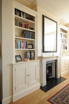 a living room filled with furniture and a fire place in front of a book shelf