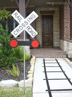 a railroad crossing sign in front of a house