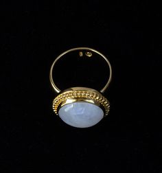 Gold Moonstone Ring Step into a world of ethereal beauty with this large Rainbow Moonstone ring handcrafted in 18K Gold Vermeil, with 18K Gold thickly coated over Sterling Silver. This captivating Balinese-style ring is a true testament to artisanal craftsmanship and the allure of Moonstones.Used in ancient rituals, Rainbow Moonstones are mystical sacred gemstones from India with beneficial healing properties to strengthen your intuition, provide protection and attract love. Every Moonstones is unique, so each ring is one of a kind.Handcrafted with passion and attention to detail, the Rainbow Moonstone Gold Vermeil ring is embellished with a Balinese-inspired design which adds a touch of exotic allure. The smooth wide band makes the ring comfortable to wear every day. Whether worn as a sym Balinese Design, Gold Moonstone Ring, Rainbow Moonstone Jewelry, Attract Love, Rainbow Moonstone Ring, Moonstone Jewelry, Ethereal Beauty, Gold Collection, Moonstone Ring